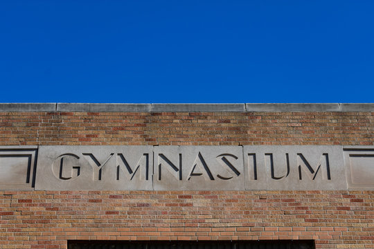 Old Gymnasium Sign On A School Building