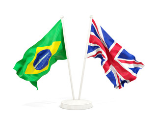 Two waving flags of Brazil and UK isolated on white