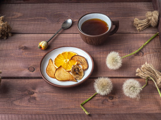 Morning coffee with fruit chips on a wooden tray