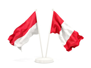 Two waving flags of Indonesia and peru isolated on white