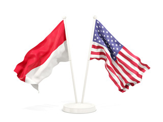 Two waving flags of Indonesia and United States isolated on white