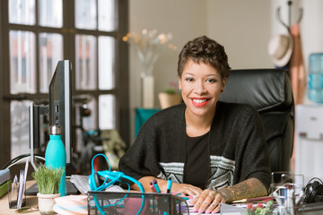 Smiling Stylish Woman in a Creative Office