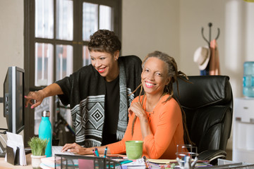 Two Women Working Together in a Creative Office