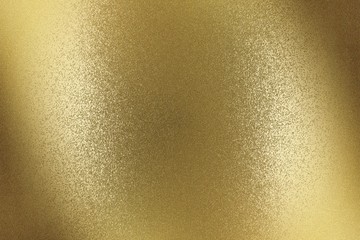 Glowing brushed bronze metal wall surface, abstract texture background