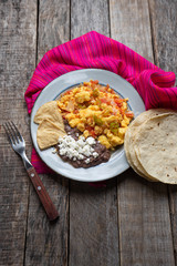 Mexican style scrambled eggs with fried beans, cheese and jalapeno