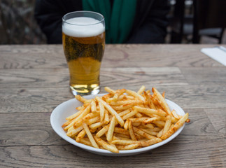 fried potatoes and beer on pub table