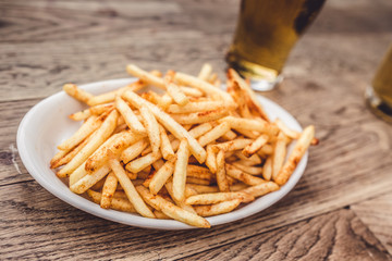 fried potatoes and beer on pub table