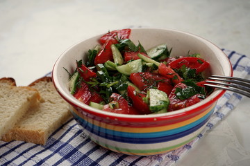 Cup with vegetable salad on light background