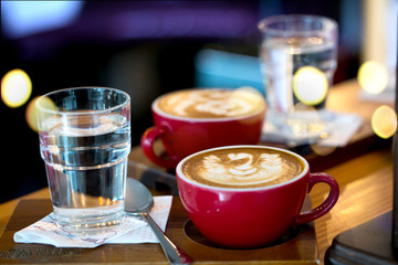 Coffee late art in cup on table