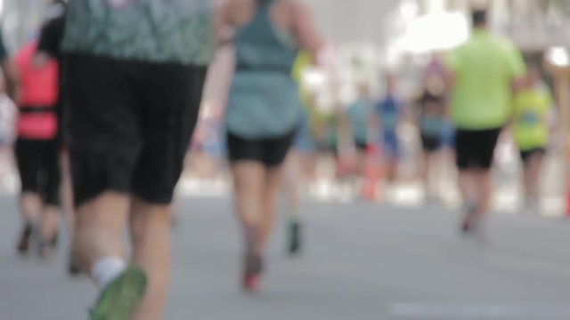 Marathon Runners Crowd Bottom-view Legs. Athletes Runing Out Off Focuss. Blurred Runner Feet Running Marathon.