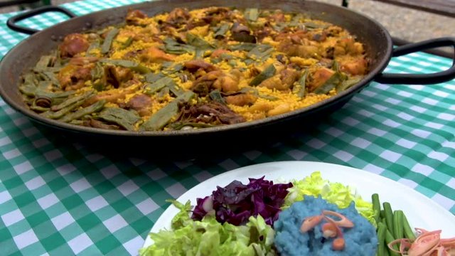 Paella and Nasi Kerabu Serve on Table
