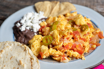 Mexican style scrambled eggs with fried beans, cheese and jalapeno