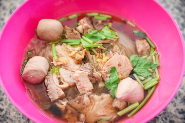 Noodles soup bowl with pork meat ball and vegetables / traditional thai and chinese style food of asian