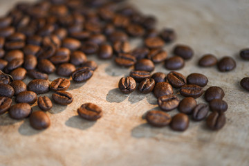 Coffee beans roasted on rustic wood background