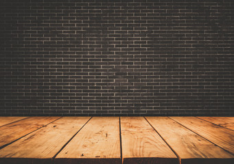 Empty wood table top with dark brick wall background