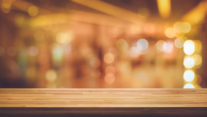 Wood texture table top (counter bar) with blur light gold bokeh in night cafe background