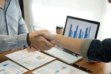 Two confident business man shaking hands during a meeting in the office, success, dealing, greeting and partner concept.