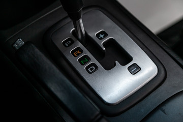 Сlose-up of the car  black interior:  dashboard,  accelerator handle, seats and other buttons.