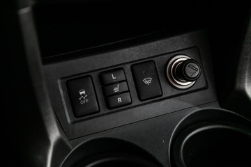 Сlose-up of the car  black interior:  dashboard, seat heating buttons., parking system, auto hold buttons and other.