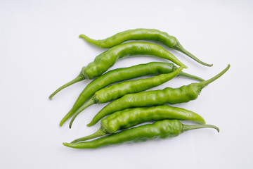 Group of fresh green chili peppers isolated on white background