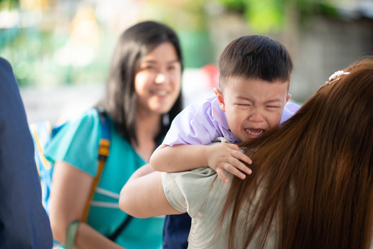 Little toddler boy cry, first day at school kindergarten with mother