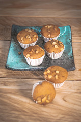Small cake made from banana milk powder on wooden floor.