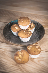 Small cake made from banana milk powder on wooden floor.