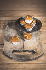 Small cake made from banana milk powder on wooden floor.