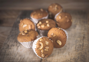 Small cake made from banana milk powder on wooden floor.