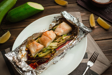 Healthy baked fish with olive oil and sauce. Menu for a cafe with homemade style cuisine.