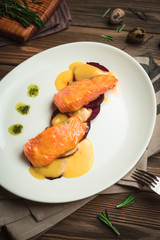 Healthy baked fish with olive oil and sauce. Menu for a cafe with homemade style cuisine.
