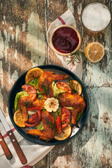 Grilled drumstick of chicken in spicy marinade with the addition of chili