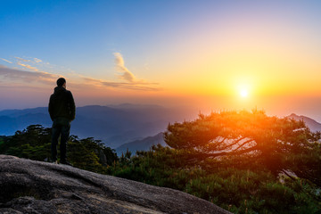 Fototapeta premium Man on top of mountain,conceptual scene