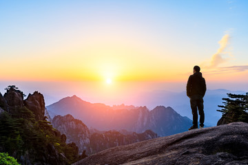 Fototapeta premium Man on top of mountain,conceptual scene