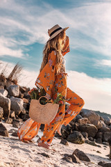 beautiful stylish boho model having fun  outdoors at sunset