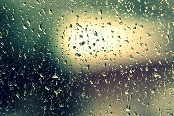 Drops of water on the glass during a thunderstorm close up. Natural background