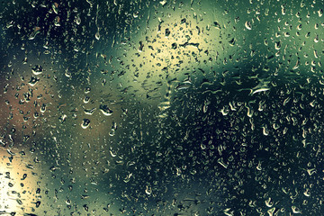 Drops of water on the glass during a thunderstorm close up. Natural background