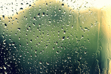 Drops of water on the glass during a thunderstorm close up. Natural background