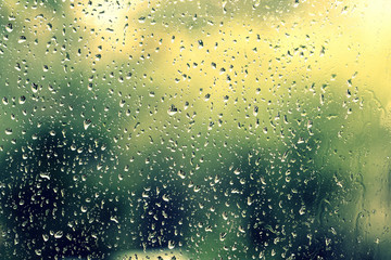 Drops of water on the glass during a thunderstorm close up. Natural background