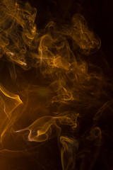 Gold smoke on black background.