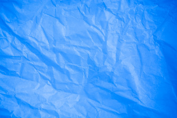 Crumpled blue paper background.