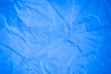 Obraz premium Crumpled blue paper background.