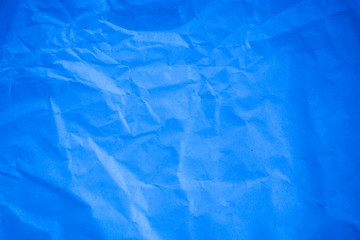 Fototapeta premium Crumpled blue paper background.