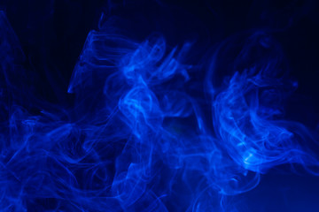 Blue smoke on black background.