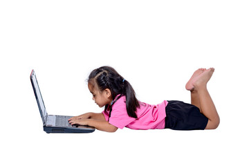 Cute little Asian girl child lying on the floor studying or using laptop isolated on white background