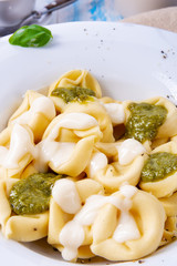 Tortellini di formaggio with basil pesto and cheese sauce