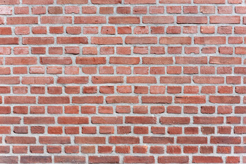 Red brick wall texture close-up background in sunlight