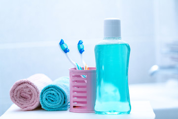 Toothbrushes and mouthwash in the bathroom at home for oral hygiene, health of teeth and gums. Fresh breath. Teeth care.