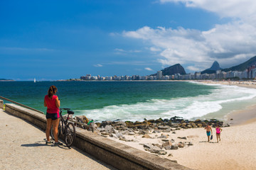 A cyclist overlook the Copacabana beach in a beautiful hot summer day, cloudy blue sky, Rio de...