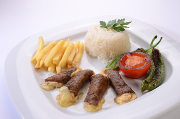 rolled beef steaks filled with cheese with salad and french fries